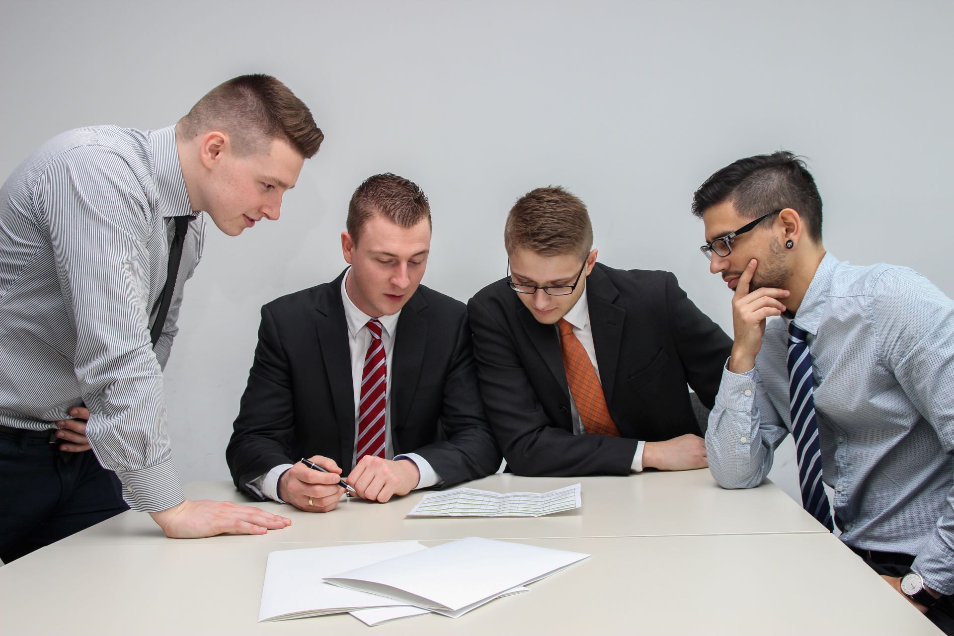 Group of young businessmen discussing finances